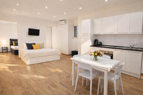 a living room with a white table and a couch at Maison TRENCA - fully equiped apartment in Menton