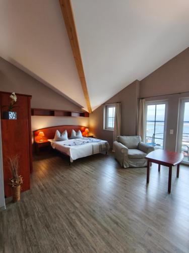 a large bedroom with a bed and a couch at Pension Hafenblick in Barth