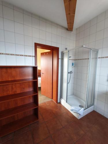 a bathroom with a shower with a glass door at Pension Hafenblick in Barth