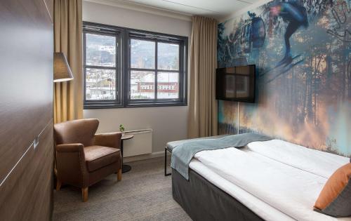 a hotel room with a bed and a chair at Scandic Hafjell in Hafjell