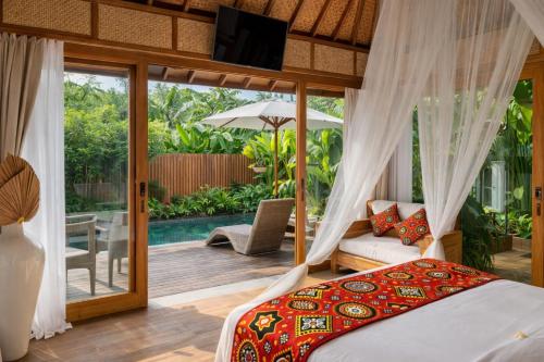 a bedroom in a villa with a bed and a patio at Kappa Senses Zanzibar in Pwani Mchangani