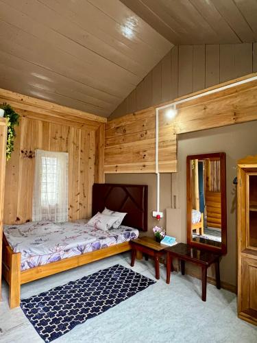 a bedroom with a bed and a table at Holiday cabin in Sibey in Hāpoli