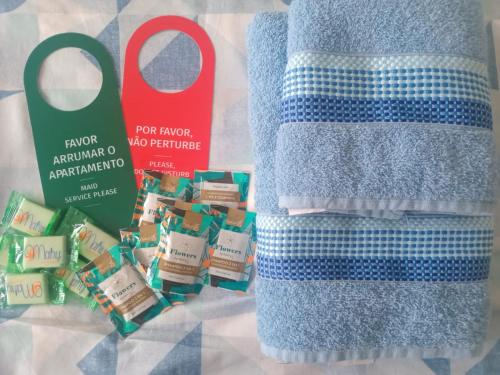 a pair of scissors next to a towel and some food at Capsula Residence Hotel in Marília