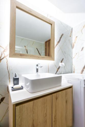 a bathroom with a sink and a mirror at Atrium The Living Experience in Malia