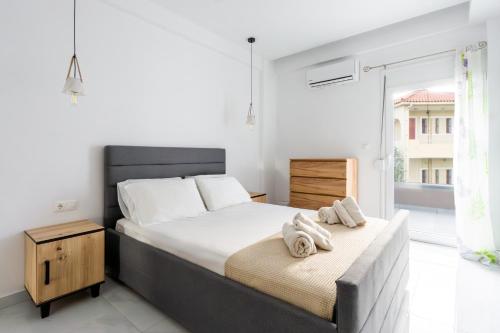 a bedroom with a large bed with towels on it at Atrium The Living Experience in Malia