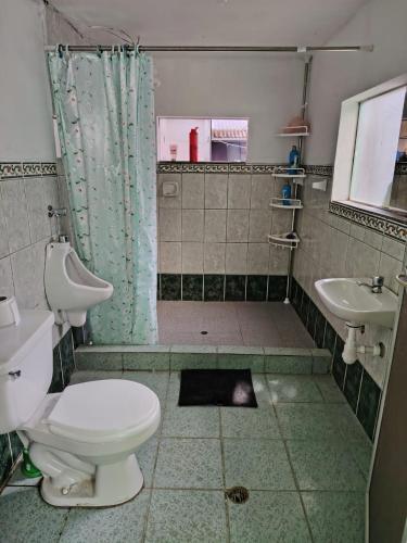 a bathroom with a shower and a toilet and a sink at Posada del Carmen 2 in Quillabamba