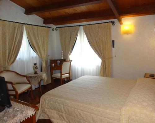 a bedroom with a bed and a table and chairs at B&B luxury San Giuseppe in Gerace