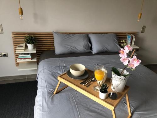 a bed with a tray with a breakfast on it at Pikermi garden suite in Pikérmion
