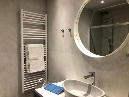 a bathroom with a sink and a mirror at Pikermi garden suite in Pikérmion