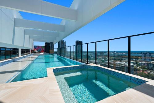 a swimming pool on the roof of a building at apartment in Tryp by Wyndham near broadwater in Gold Coast