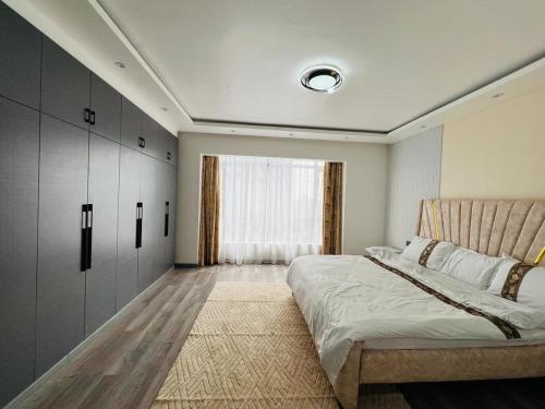 a bedroom with a large bed and a window at Diamond Oark Residency in Gatunga