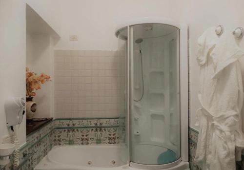 a bathroom with a shower and a tub at B&B luxury San Giuseppe in Gerace