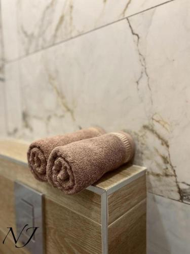 a couple of towels sitting on a counter in a bathroom at NJ Collection in Varna City