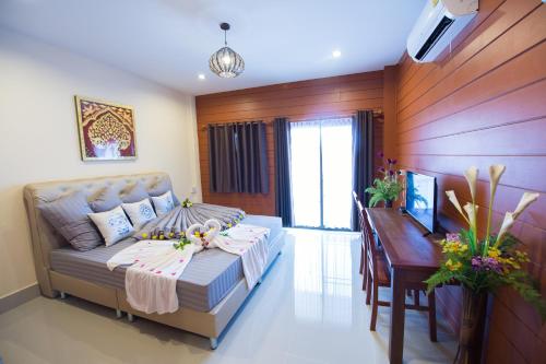 a living room with a couch and a table at Sri Siam Resort in Kanchanaburi City