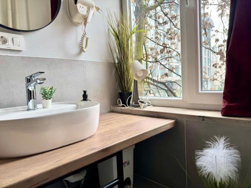 a bathroom with a sink and a window at E - Central Room Two in Skopje