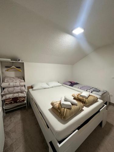 a bedroom with two beds with towels on them at Apartments Aventra in Visoko