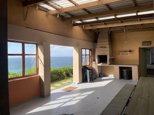 a living room with a view of the ocean at Jabula Beach House in Mngazana