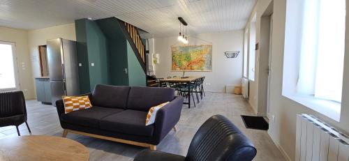 a living room with a couch and a table at Gite Les 4 Moustaches in Bourbourg