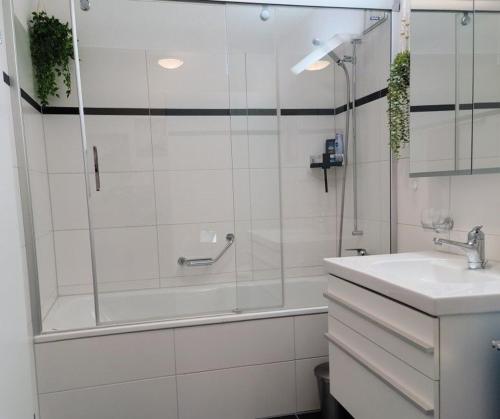 a bathroom with a shower and a sink at Apartment Keller in Savognin