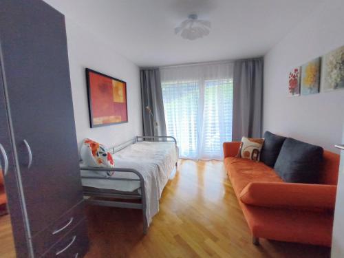 a living room with a bed and a couch at Apartment Keller in Savognin