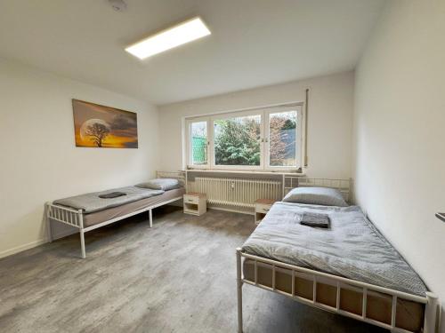 a room with two beds and a window at Nice Apartments in Gelnhausen in Gelnhausen