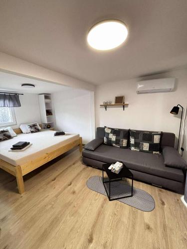 a living room with a bed and a couch at Moon apartments in Pakoštane