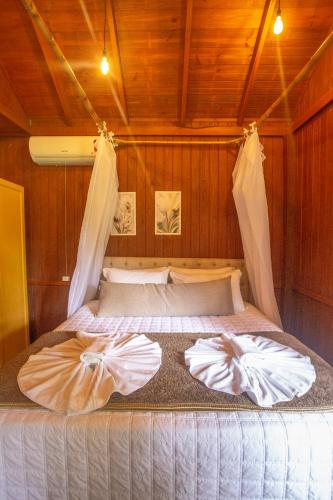a bedroom with a bed in a room at Pousada Fazenda Caetés in Camboriú