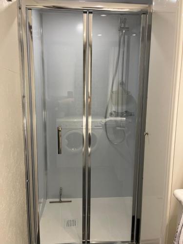 a shower with a glass door in a bathroom at Gîte Pierre et Meuse in Fumay