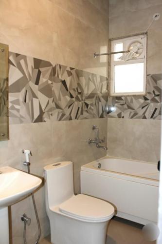 a bathroom with a toilet and a sink at Shagun Hotel & Banquet in Lucknow