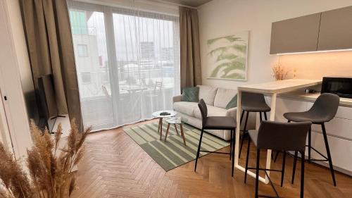 a kitchen and living room with a table and chairs at VApartment Nova Vajnorska , private parking in Koliba