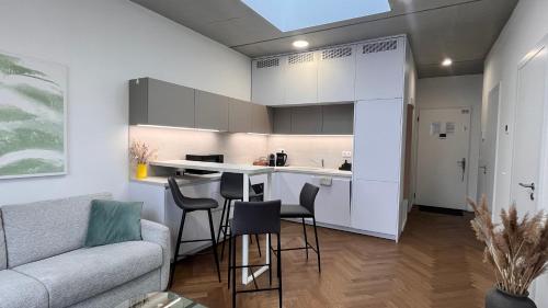 a kitchen and living room with a couch and a table at VApartment Nova Vajnorska , private parking in Koliba