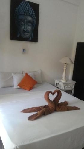 a pair of snakes forming a heart on a bed at Puri Oka Beach Bungalows in Candidasa
