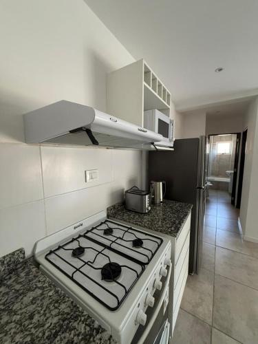 a kitchen with a stove top oven in a kitchen at Altostay in Villa Constitución