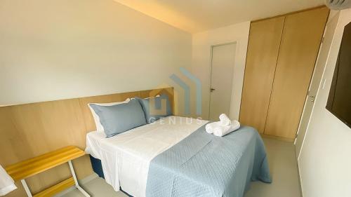 a small bedroom with a bed and a table at Unigreen Manaíra Genius Flats in João Pessoa