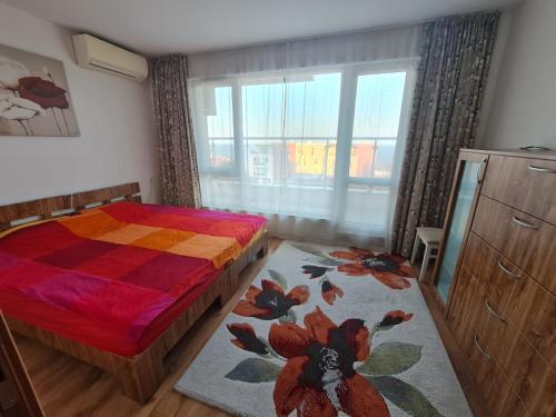 a bedroom with a bed and a large window at Large Two Floor Apartment in Byala