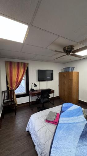 a bedroom with a bed and a desk and a television at Private 1BR Near Boston -- Kitchen & Laundry in Malden