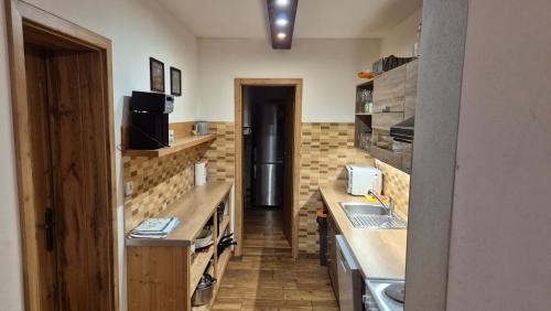 a small kitchen with a counter and a sink at Chaty Slovensky Raj Veronika in Smižany