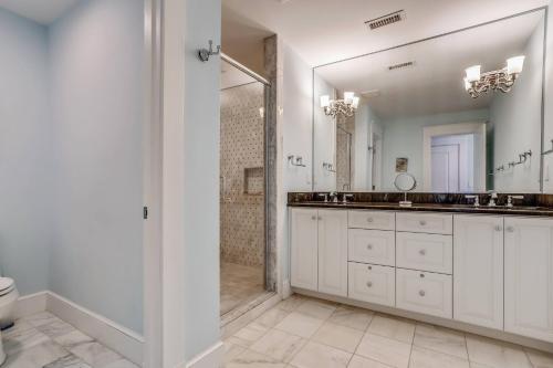 a white bathroom with two sinks and a shower at Frankly My Dear - Duck, Oceanfront, Elevator, Wheelchair Friendly, Pool Table, Pool, Hot Tub, Flex Stays in Duck