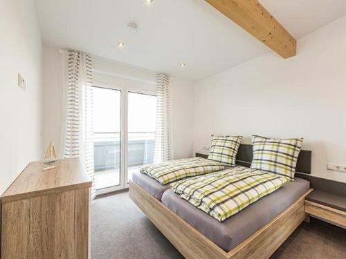 a bedroom with a bed and a large window at Ferienhof Raither in Immenstaad am Bodensee