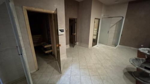 a bathroom with a walk in shower and a mirror at Aspen Golf Resort Studio E206 in Bansko