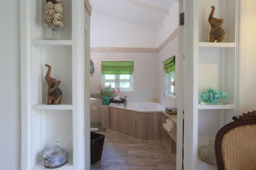 a bathroom with a bath tub and a sink at 3 Bedroom Villa with Pool and Ocean Views in Cap Estate