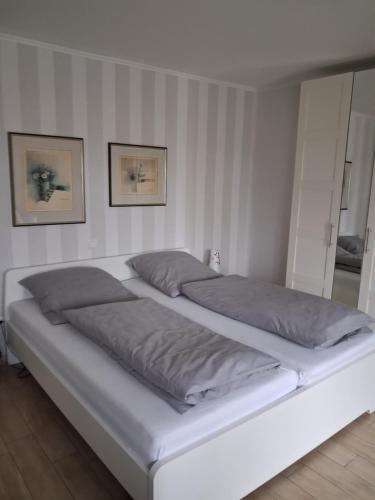 a bed in a room with two pillows on it at Appartment am Fingerhut in Cloppenburg