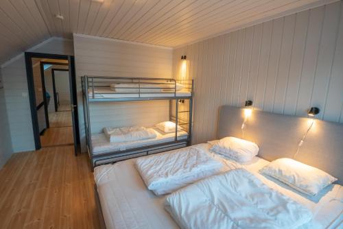 a bedroom with two bunk beds in a room at Bakkebyvegen 22A in Trysil