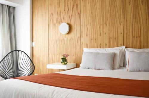 a bedroom with a bed with a wooden wall at Deco Collection in Buenos Aires