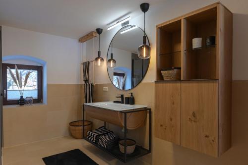 a bathroom with a sink and a mirror at Traunreiter Apartment in Bad Goisern
