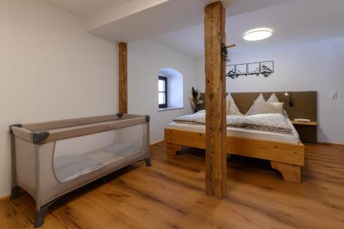 a bedroom with a bed with a wooden frame at Traunreiter Apartment in Bad Goisern