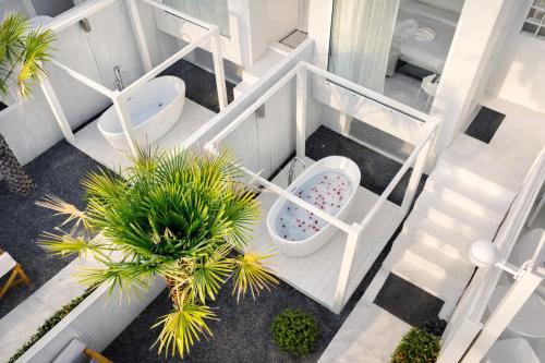 an overhead view of a bathroom with a toilet and a plant at Sela Lanta in Ko Lanta