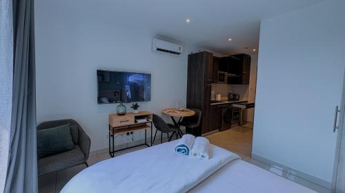 a living room with a bed and a kitchen at The Loxwood House Studio in East Legon