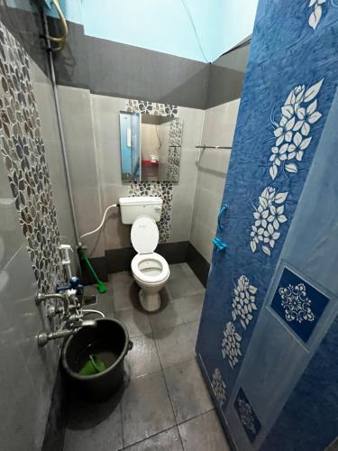 a small bathroom with a toilet and a sink at Unique Stays in Pondicherry