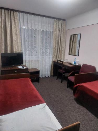 a hotel room with a bed and a dining room at Motel Poltava in Poltava